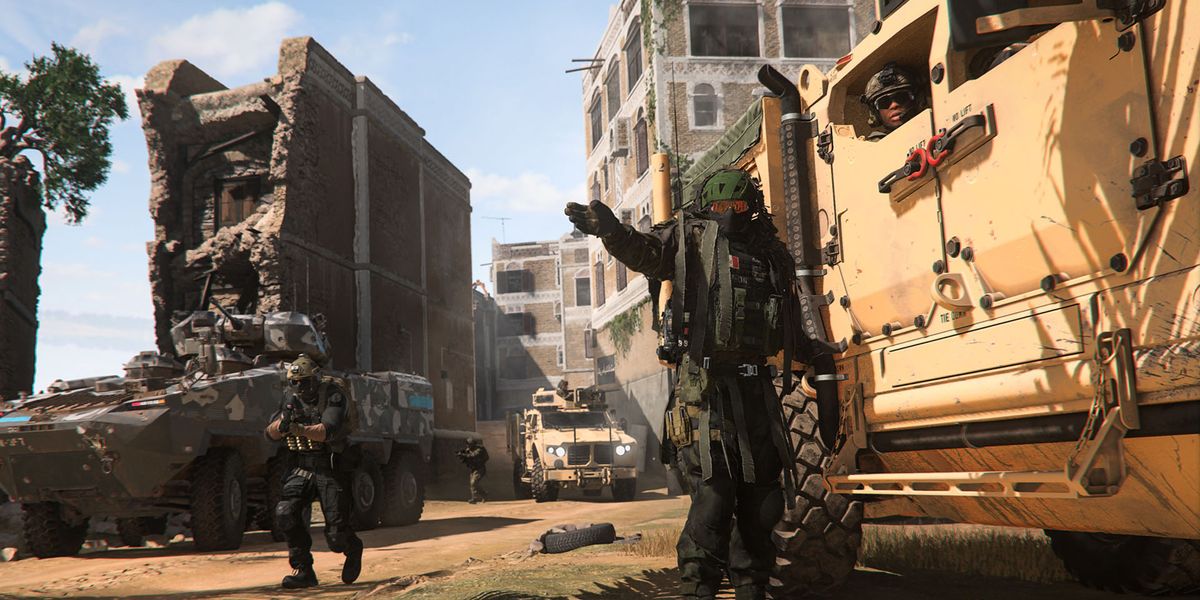 Screenshot showing Modern Warfare 2 players standing next to vehicles in a desert city